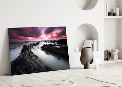 Crimson Sky Over Black Rocks Glass Wall Art