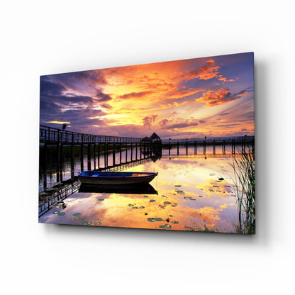 Rowboat by Pier Under Fiery Clouds Glass Wall Art