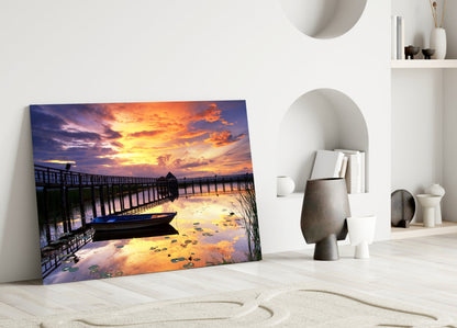 Rowboat by Pier Under Fiery Clouds Glass Wall Art